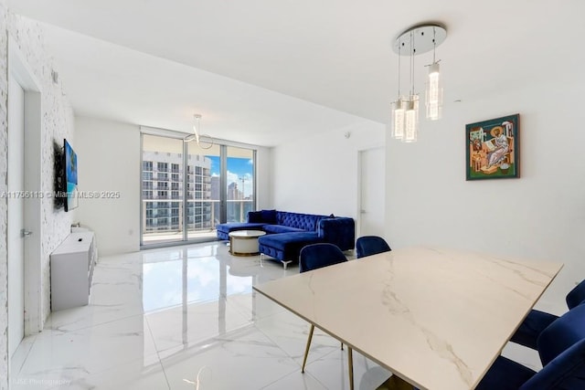 dining area with marble finish floor and a wall of windows