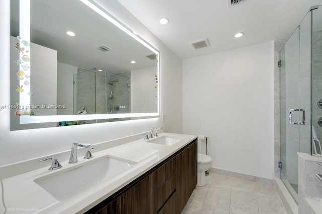 bathroom with a shower stall, visible vents, and a sink