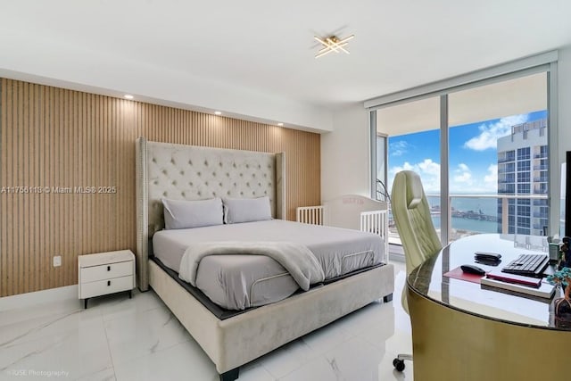 bedroom with expansive windows, marble finish floor, access to outside, and wooden walls