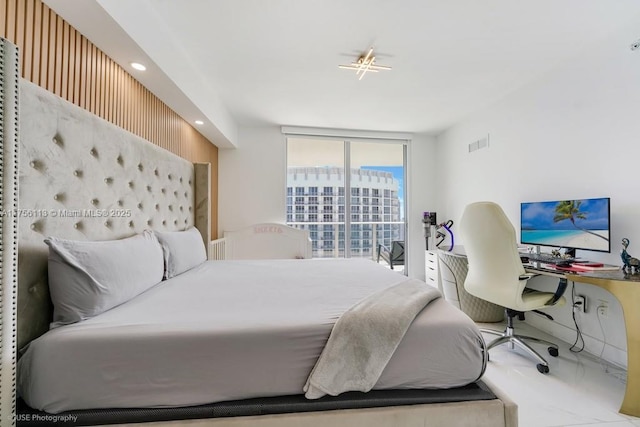 bedroom with expansive windows, visible vents, and recessed lighting