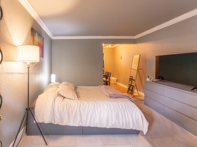 bedroom with ornamental molding and baseboards