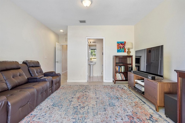 living area with visible vents and light tile patterned floors