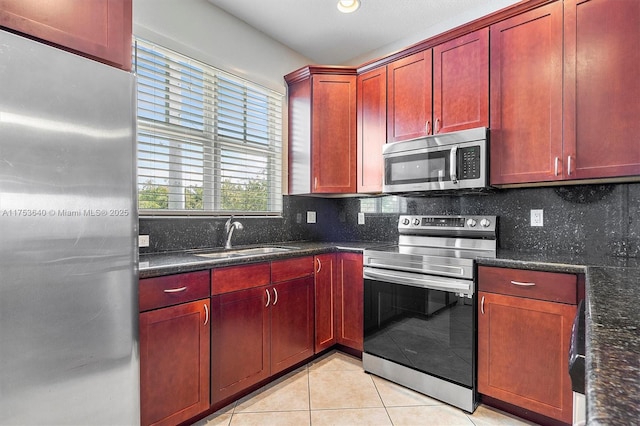 1835 N Dixie Hwy, Fort Lauderdale, FL 33305 - kitchen with decorative backsplash, a sink, stainless steel appliances, dark brown cabinets, and light tile patterned flooring