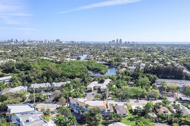 birds eye view of property with a water view and a city view