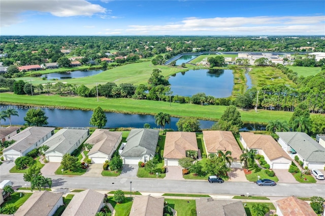 drone / aerial view featuring a water view and a residential view