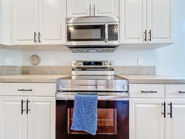 kitchen featuring white cabinets, stainless steel appliances, and light countertops