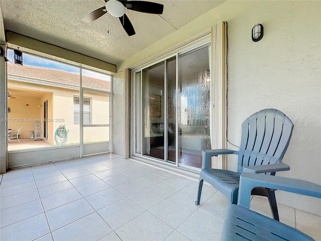 sunroom featuring ceiling fan