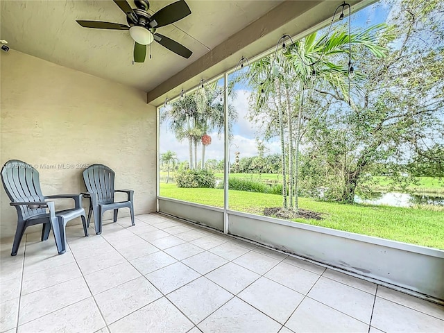 unfurnished sunroom with a ceiling fan