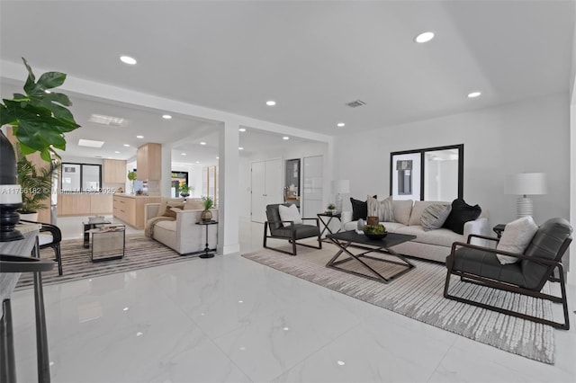 living area featuring visible vents, recessed lighting, and marble finish floor