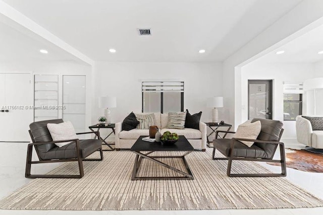 living room featuring recessed lighting and visible vents