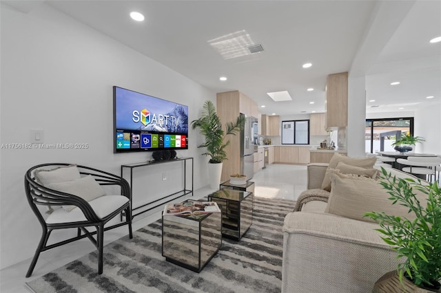 living area featuring recessed lighting and light tile patterned floors