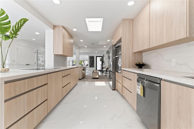 kitchen featuring dishwasher, light brown cabinets, and modern cabinets