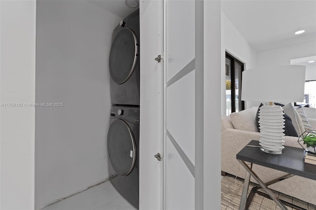 laundry area featuring laundry area, stacked washer and dryer, and recessed lighting