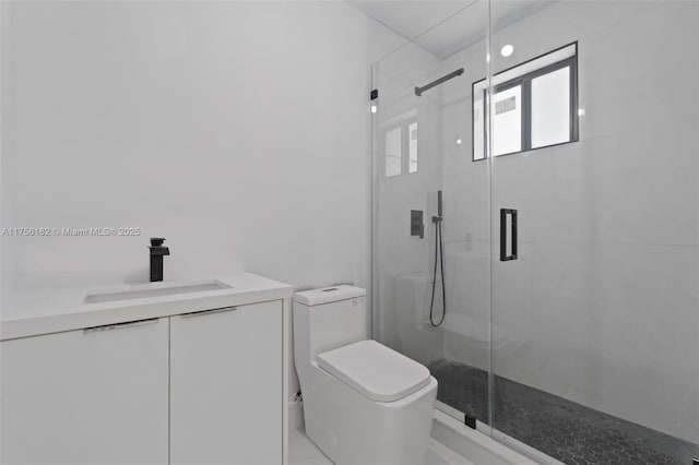 full bath with toilet, vanity, and a shower stall