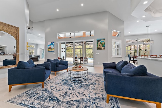 living area with a towering ceiling and recessed lighting