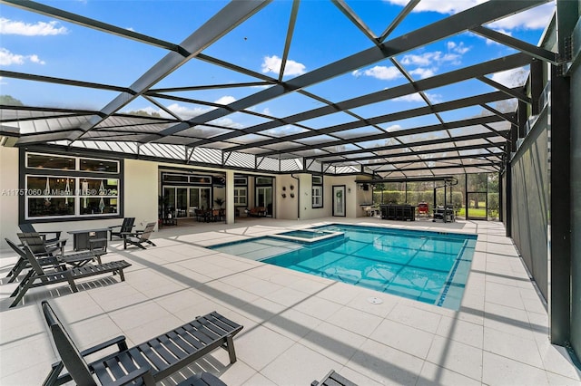 view of swimming pool with a patio, a lanai, and a pool with connected hot tub