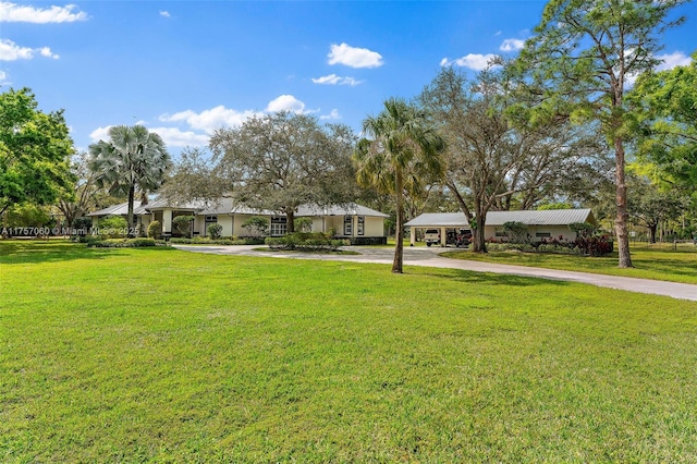 view of front of property with driveway and a front lawn