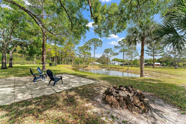 view of home's community with a lawn and a water view