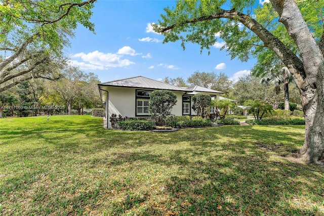 exterior space with a lawn and stucco siding