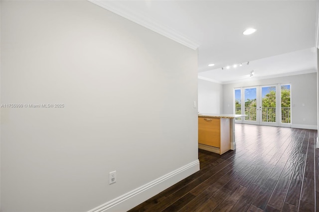 unfurnished room with baseboards, ornamental molding, dark wood-type flooring, french doors, and recessed lighting