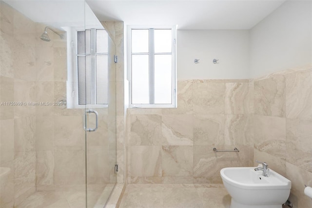 full bath with a shower stall, a bidet, and tile walls