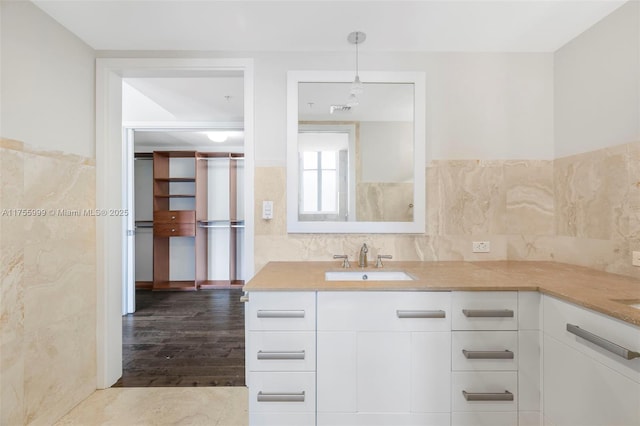 full bath with backsplash, wood finished floors, and vanity