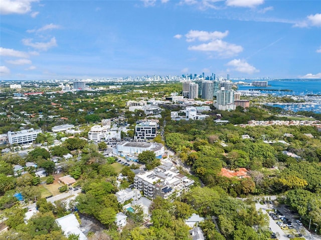 birds eye view of property with a view of city and a water view