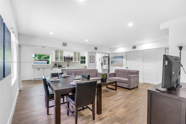 dining space featuring recessed lighting, visible vents, and light wood-style floors