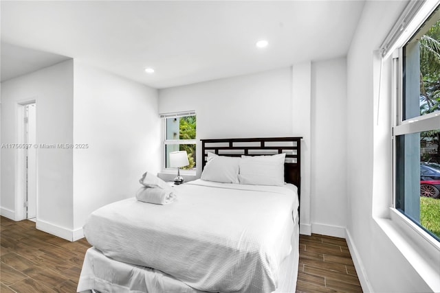 bedroom with baseboards, wood finished floors, and recessed lighting