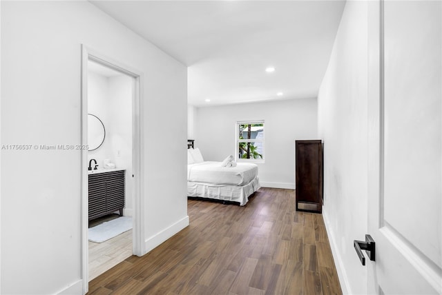 bedroom with recessed lighting, baseboards, and wood finished floors