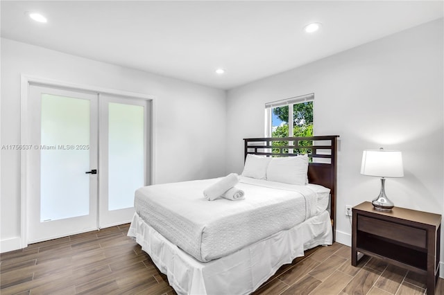 bedroom with wood tiled floor, french doors, baseboards, and recessed lighting