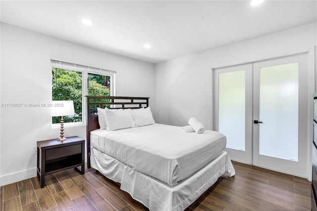 bedroom with baseboards, french doors, dark wood-style flooring, and recessed lighting