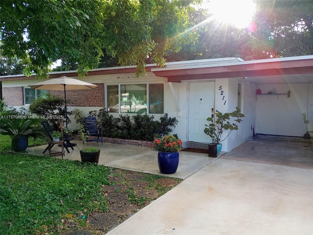 view of front of home with stucco siding and brick siding