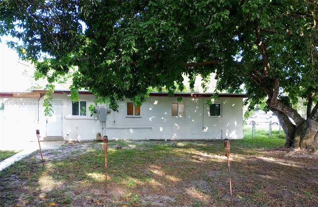 ranch-style home with stucco siding