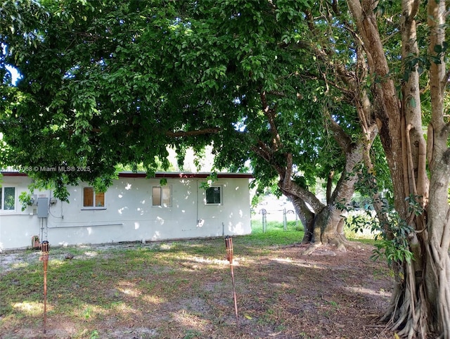 view of side of home with stucco siding