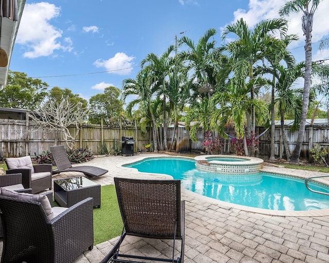 view of pool featuring a fenced backyard, a grill, a patio area, a pool with connected hot tub, and outdoor lounge area