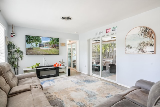 living room featuring baseboards and visible vents