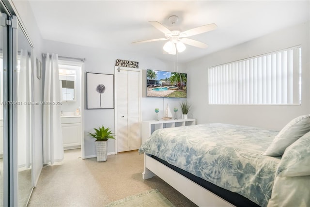 bedroom featuring ceiling fan, connected bathroom, and a closet