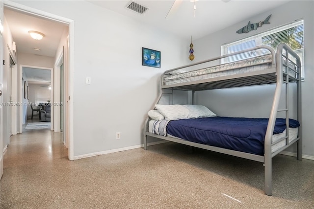 bedroom with baseboards, visible vents, and speckled floor