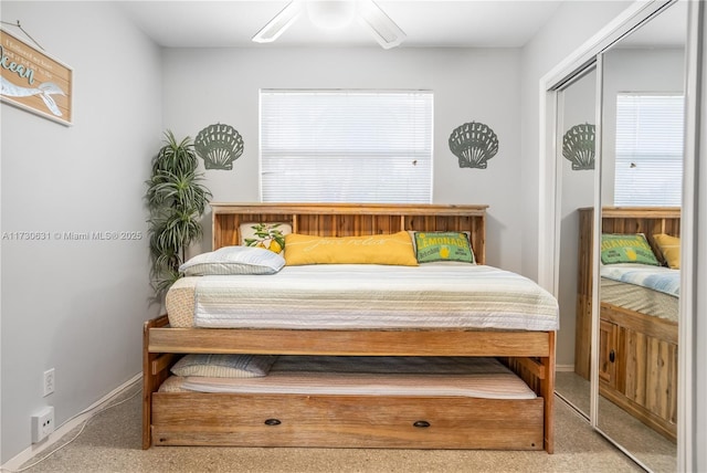 carpeted bedroom featuring ceiling fan, baseboards, and a closet