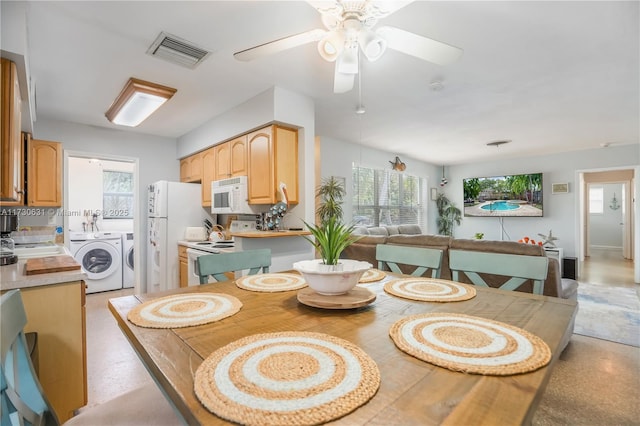 dining room with washing machine and dryer, visible vents, and a ceiling fan