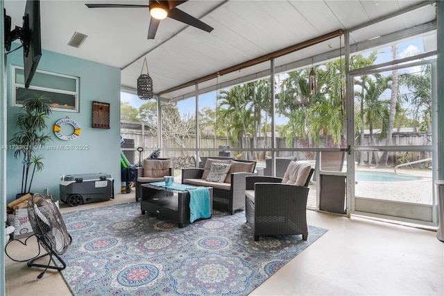 sunroom featuring visible vents, a ceiling fan, and a healthy amount of sunlight