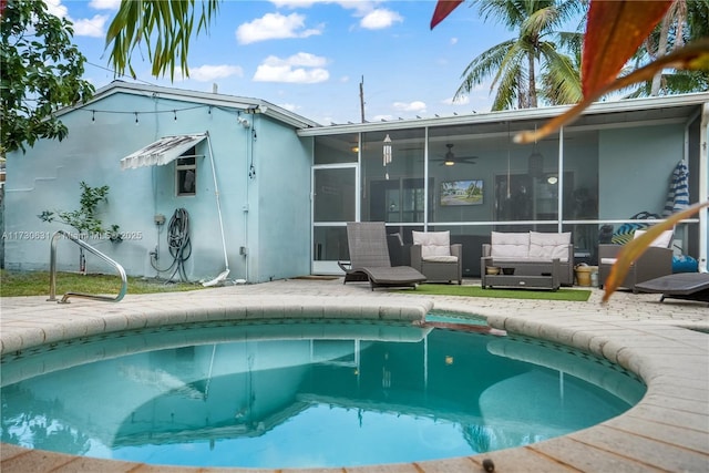 outdoor pool with an outdoor hangout area, a patio area, and a sunroom