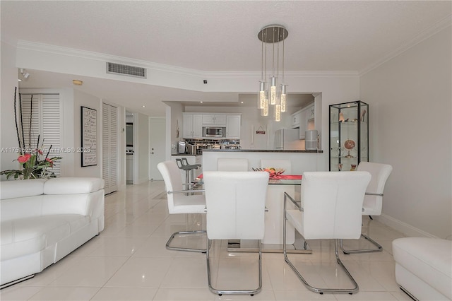 dining area with baseboards, visible vents, a textured ceiling, crown molding, and light tile patterned flooring