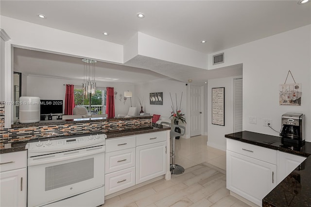 kitchen featuring tasteful backsplash, white cabinets, visible vents, and white range with electric cooktop