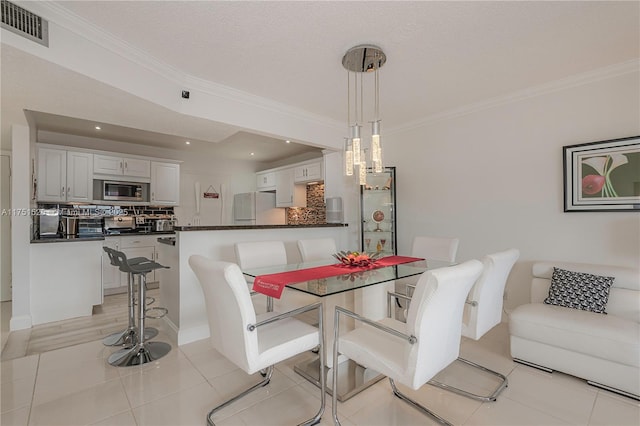 dining area with light tile patterned floors, visible vents, crown molding, and recessed lighting