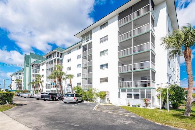 view of property featuring uncovered parking