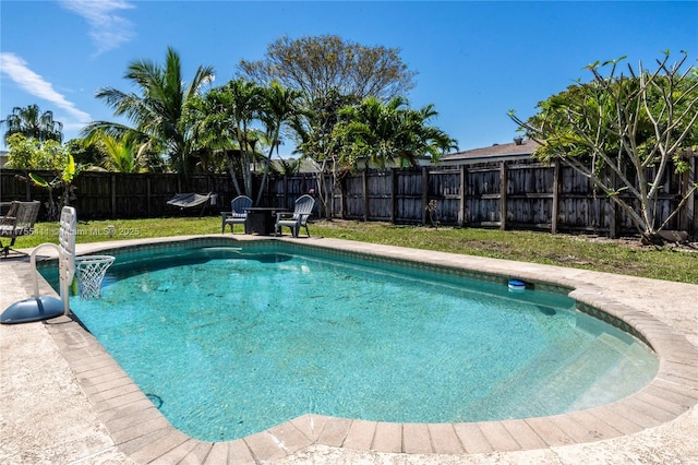 view of swimming pool featuring a fenced in pool, a fenced backyard, a yard, and a patio