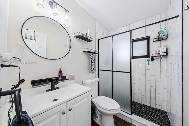 full bathroom with a shower stall, toilet, and vanity