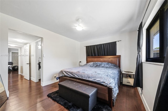 bedroom featuring baseboards and wood finished floors